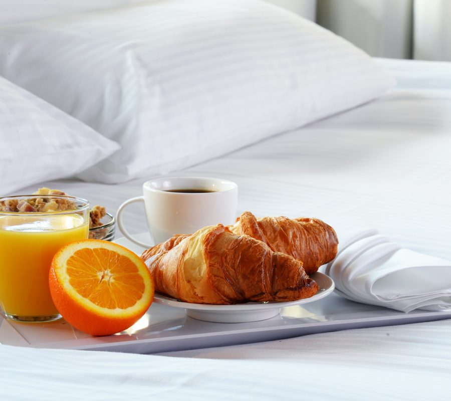 Breakfast in bed in hotel room. Accommodation.
